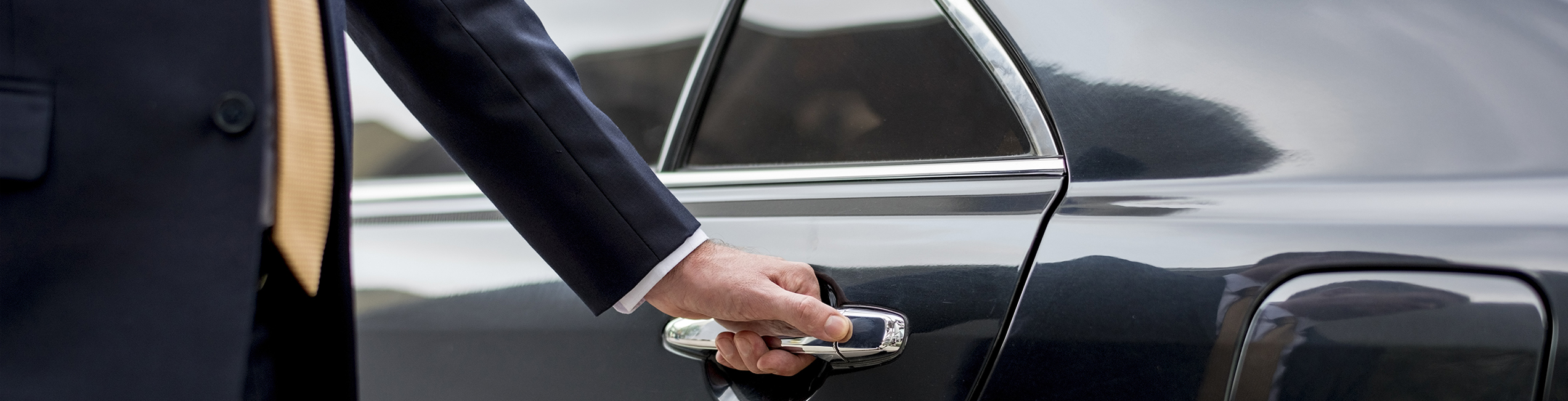 Chauffeur opening a car door