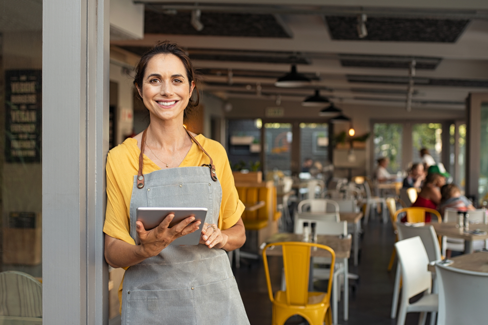 Waitress standing in front of café